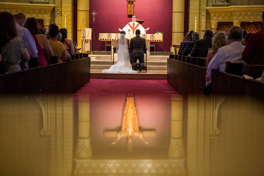 Couple kneeing during mass