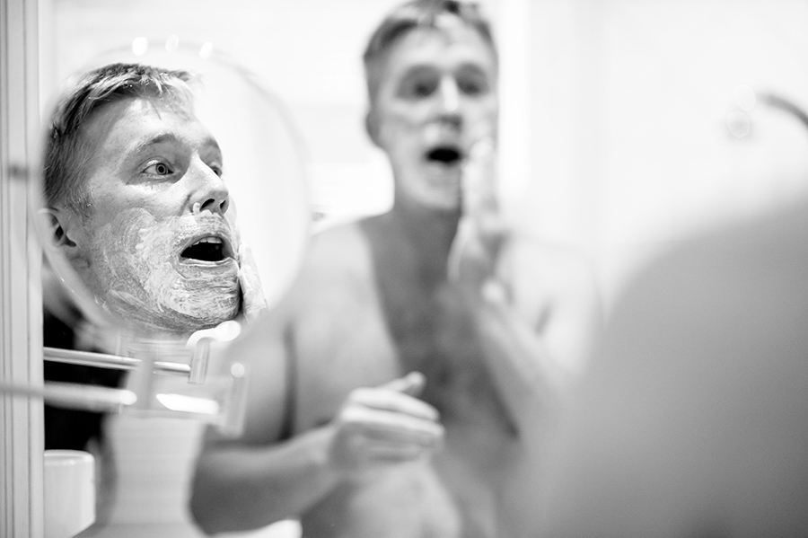 Groom shaves on his wedding morning.