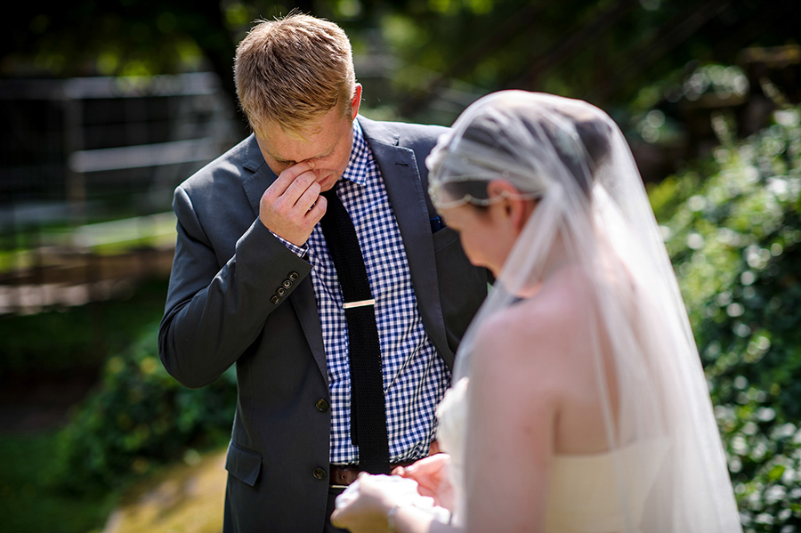 Groom cries during his vows at wedding ceremony.