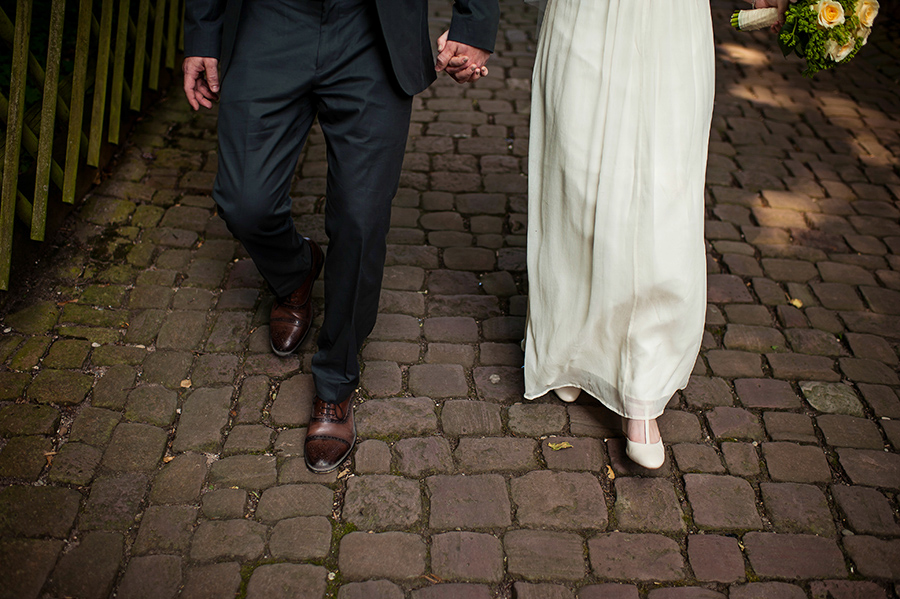 Bride and groom walk on German streets to wedding reception.