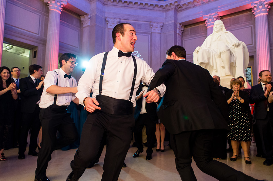 Groomsmen and groom dance at reception.