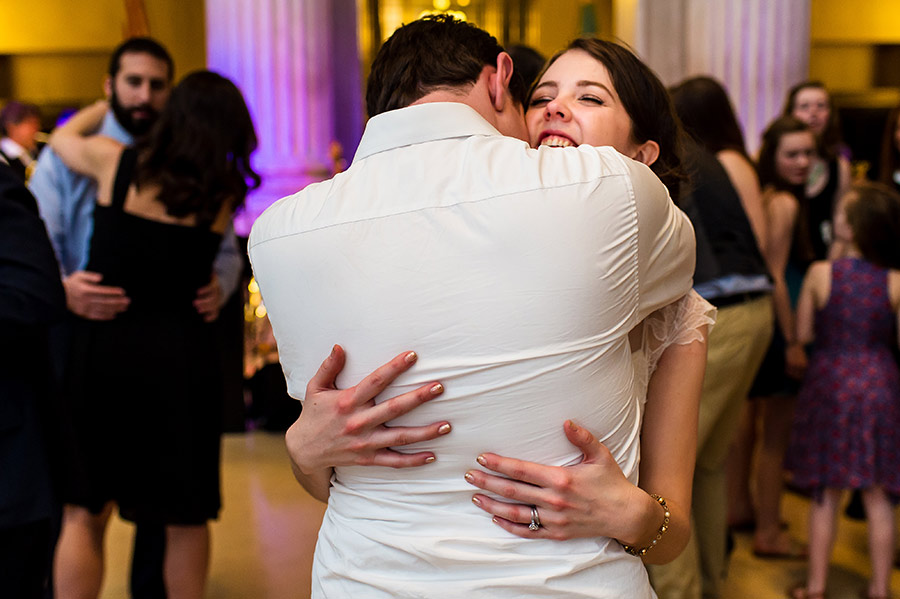 Bride hugging groom at the end of their wedding reception.