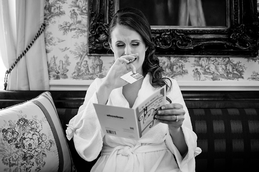 Bride crying as she read card from groom.