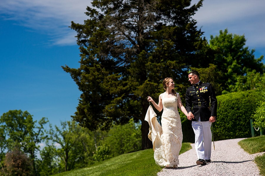 Bride and groom walking together down a path.