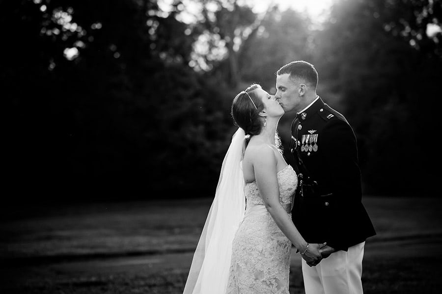 Bride and groom kissing in the evening light.