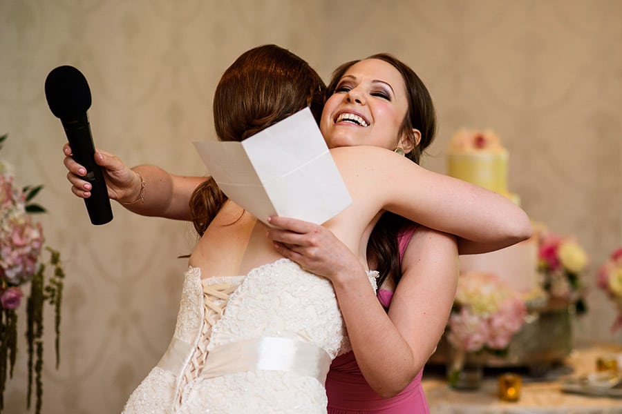 Bride hugging the maid of honor after her speech.