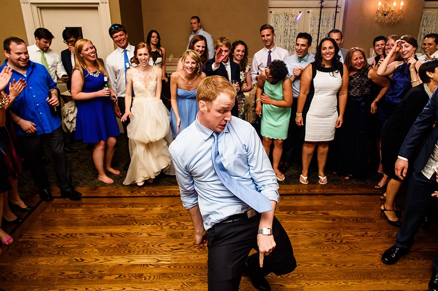 Wedding guests dancing in the middle of a group at the reception.