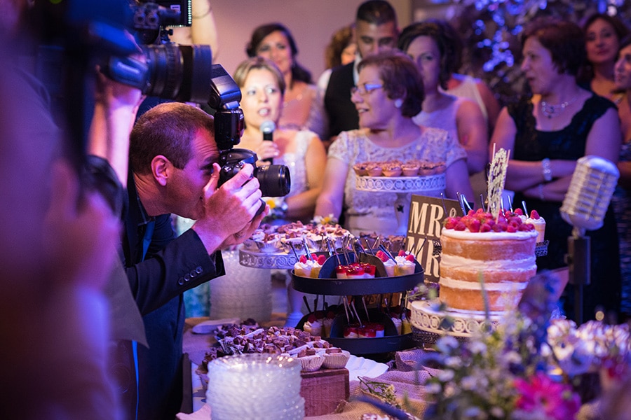 Philadelphia photographer capturing cake cutting during wedding reception.