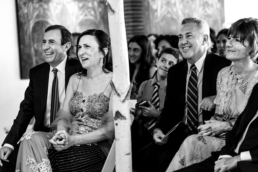 Groom's parents laugh during the wedding ceremony.