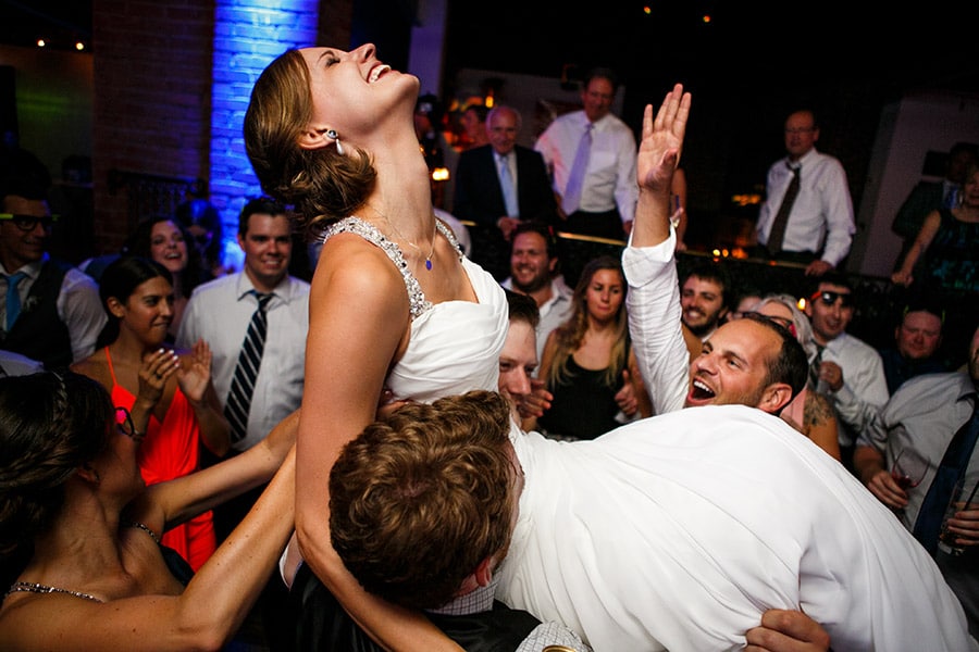 Bride is thrown into air during wedding reception.