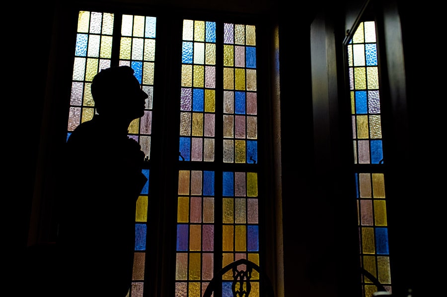 Silhouette of a groom preparing for wedding ceremony.