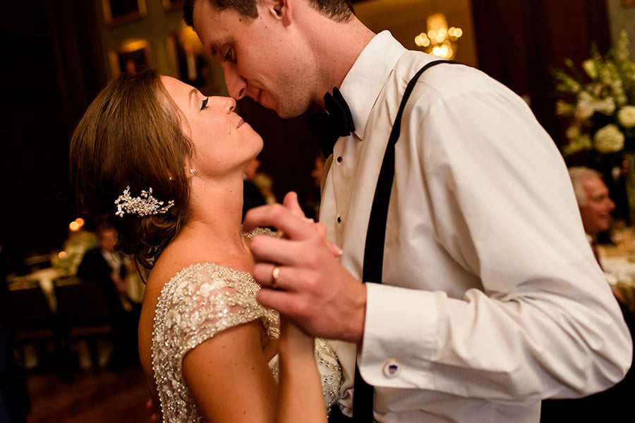 Bride and groom rub noses on the dance floor during wedding reception.
