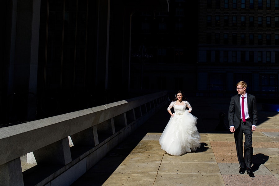 Bride and groom walking in Center City Philadelphia on their wedding day.