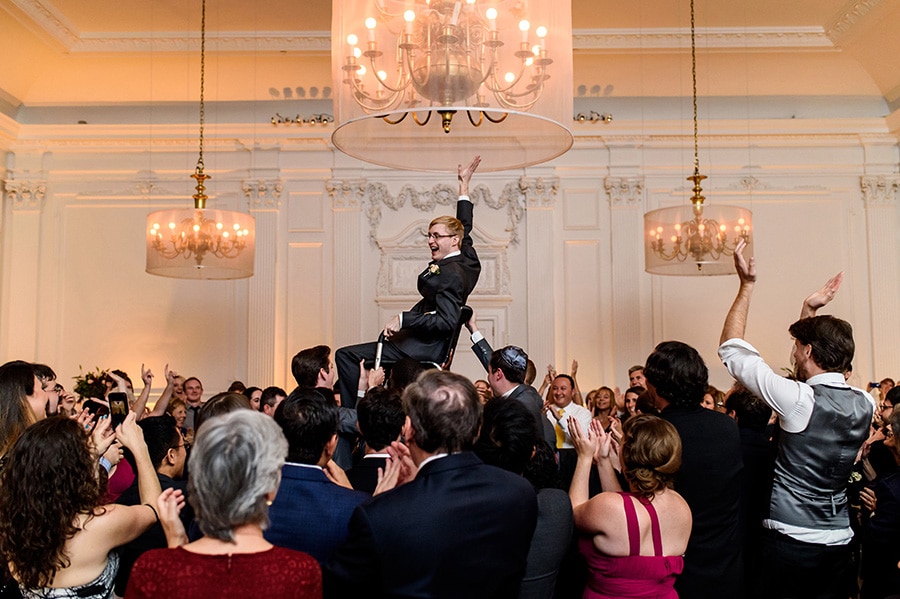 Groom is lifted in a chair during the Horah!