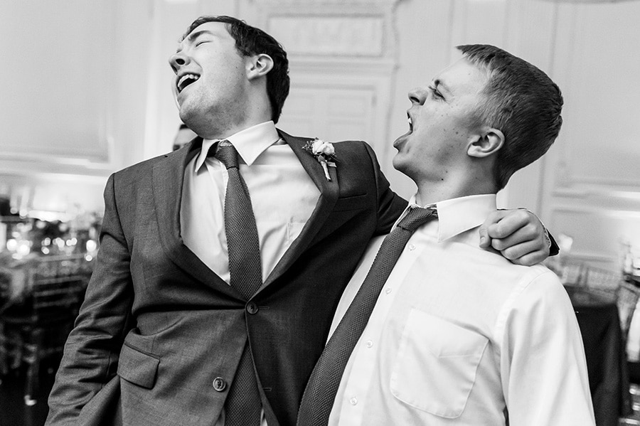 Best man and groomsmen sing along during wedding reception.