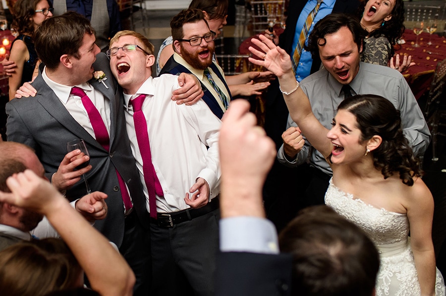 Best man, groom, bride and weddings guests pack the dance floor during a favorite song!