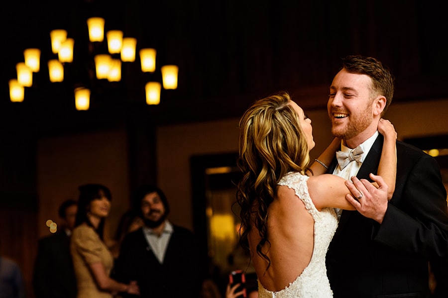 Groom smiles at bride during the first dance of their wedding reception at Bear Creek Mountain Resort.